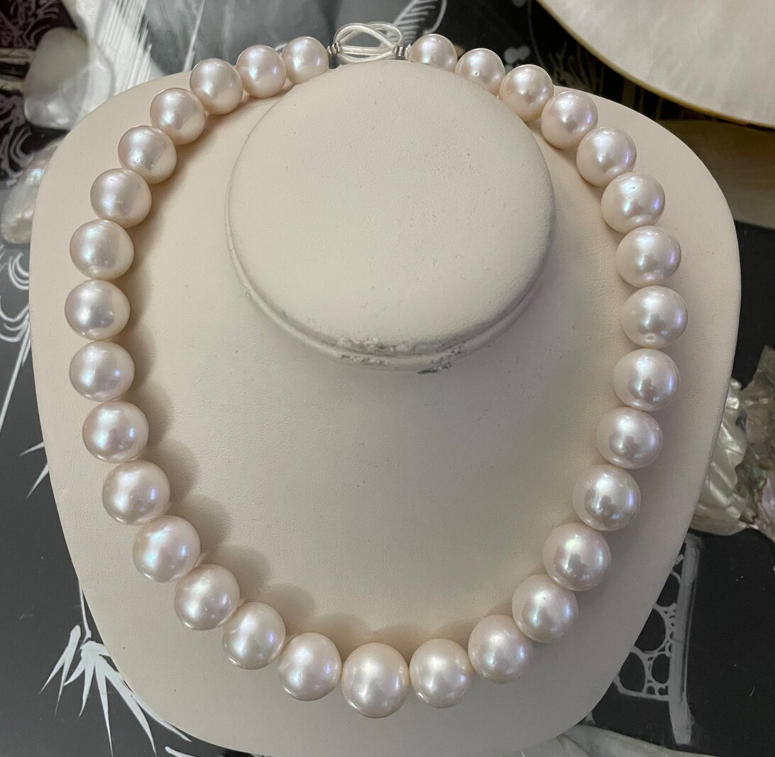 White freshwater pearl strand. 14k gold ball clasp