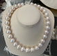 White freshwater pearl strand. 14k gold ball clasp