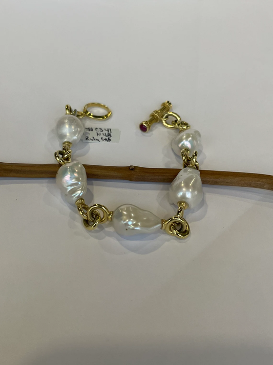 14k Gold. Bracelet. Featuring baroque freshwater pearls, with a toggle clasp