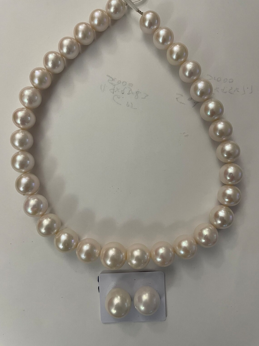 White freshwater pearl strand. 14k gold ball clasp